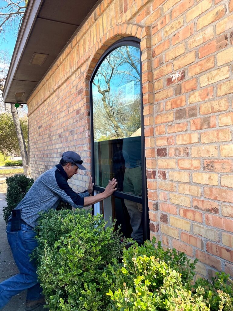 A-man-installing-energy-efficient-picture-replacement-windows-in-Doral-FL